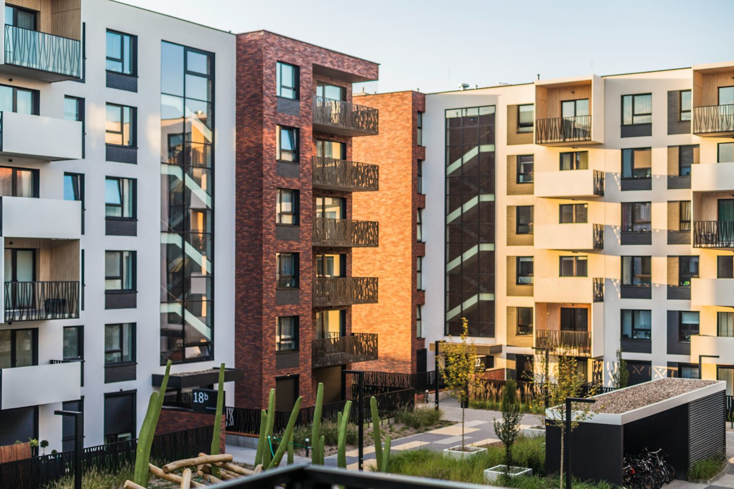 Modern apartment buildings with balconies and glass windows.